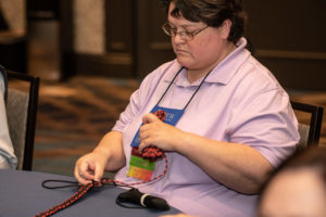 Photo of woman tying a macrame dog leash