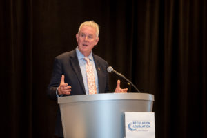 photograph of Tommy Wells at podium