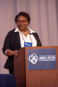 Photograph of Kenya Anderson speaking at a podium