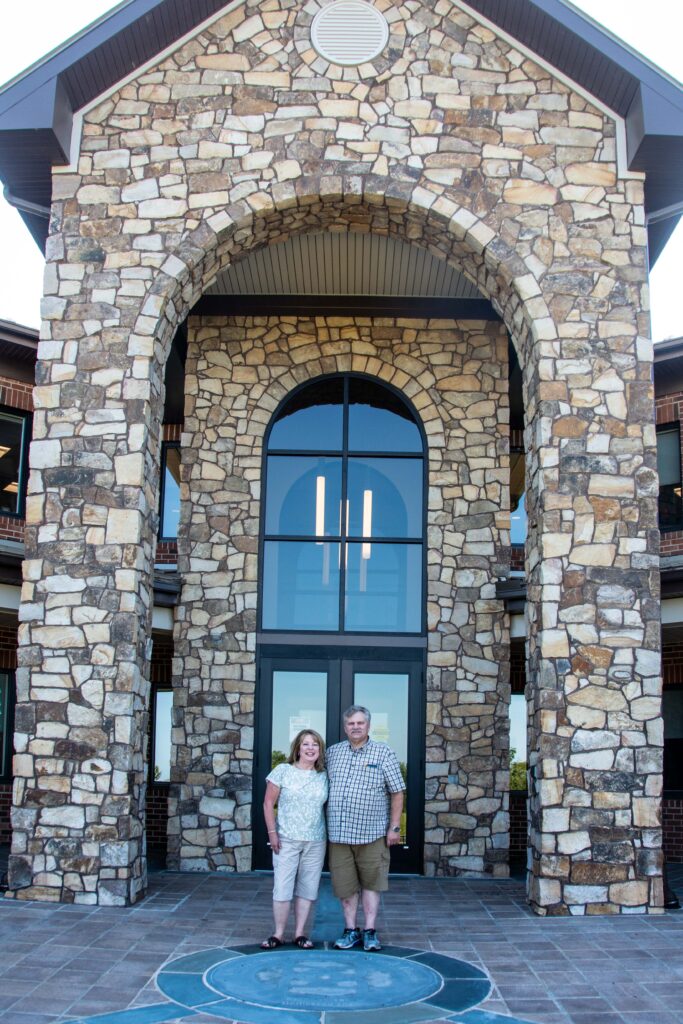 Photograph of Carol and John Payne in front of ASWB headquarters