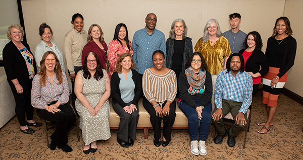 Photograph of 17 people arranged both seated and standing.