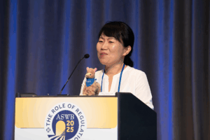 Photograph of Dr. Joy Kim speaking at a podium.